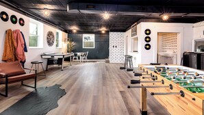 A room with a foosball table, a pool table, and a dartboard. - Cozy, sleeps 20 retreat in Auburn game area and large family entertaining (Auburn)