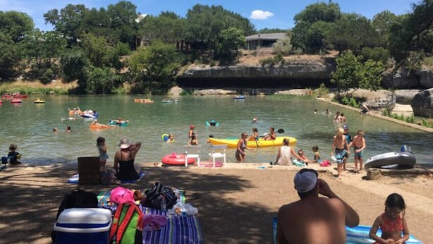 Une zone riveraine où l’on peut pratiquer des activités nautiques, avec des bateaux et une plage de sable.