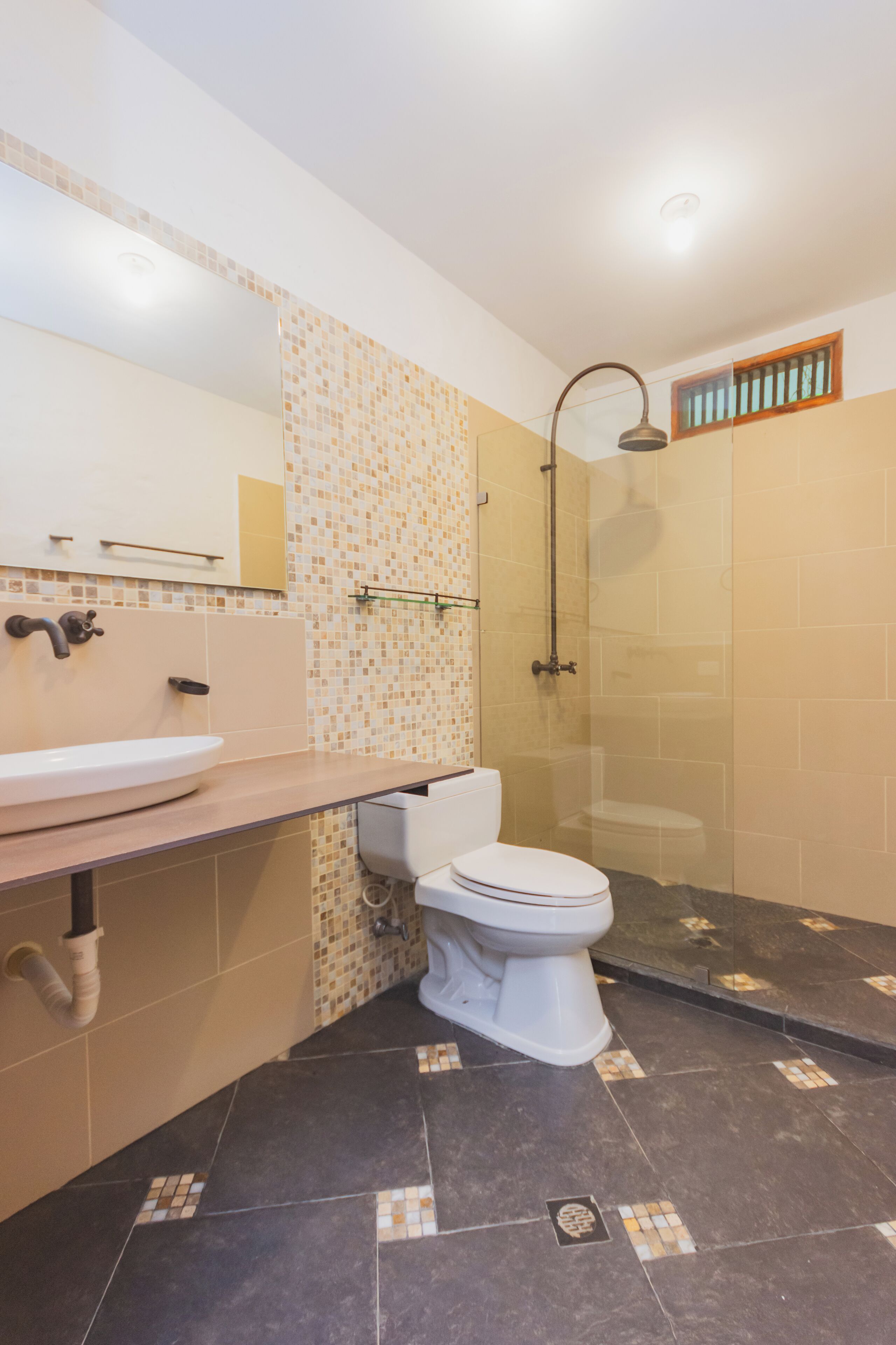 A bathroom with a sink, toilet, and shower.