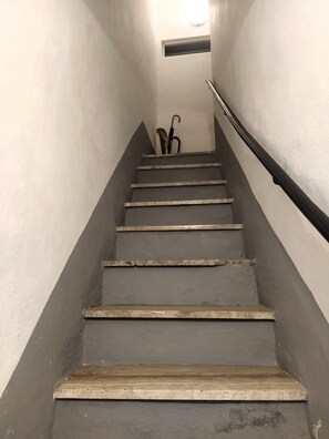 Stairs lead to an upper floor with a handrail for support.