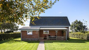 A single-story brick house with a tiled roof, a front porch, and a number '34' sign. - Awesome home in Tønder with WiFi (Tønder)