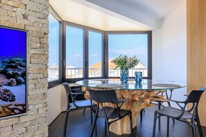Enjoy meals in this stylish dining area with a round table, four chairs, and a beautiful view.