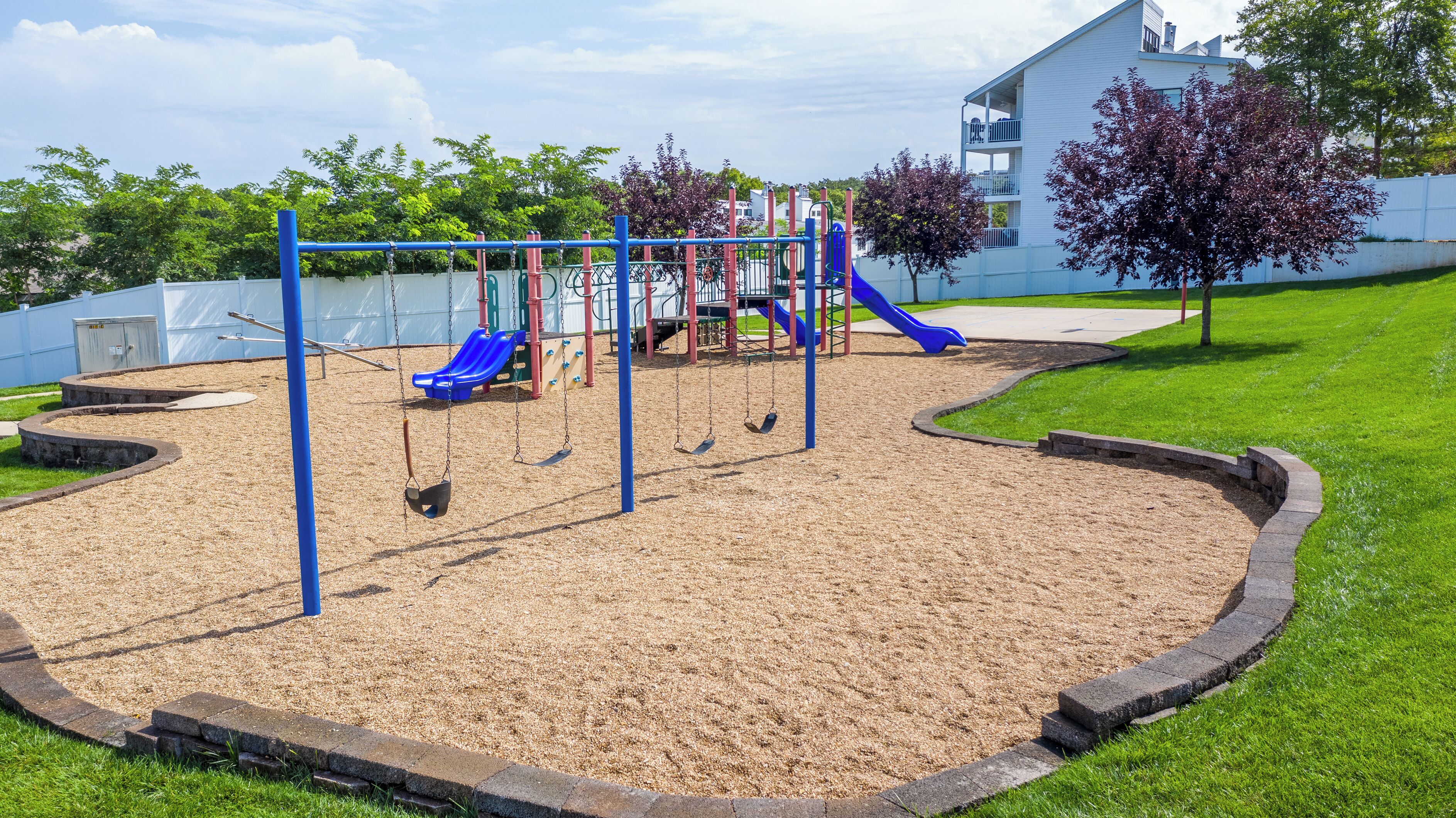 A playground with swings, slides, and a climbing structure.