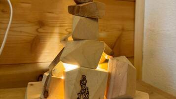 A wooden sculpture with geometric shapes stacked on a wooden base.