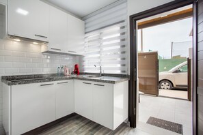 Fridge, microwave, stovetop, coffee/tea maker