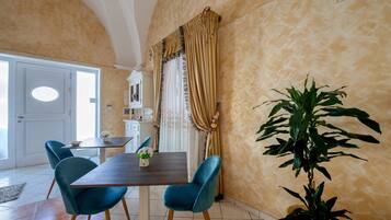 A dining area with a table, chairs, and curtains.