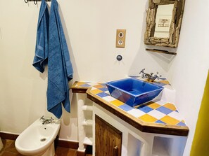 A bathroom with a blue sink, a bidet, and a mirror with a rustic frame. - Las Palomas Coastal Retreat, Tarifa sleeps 2-4 (Tarifa)