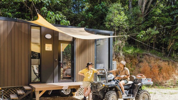 A wooden cabin with a sliding door, a picnic table, and a canopy. - Raspberry Spring Corner by Tiny Away (Clothiers Creek)