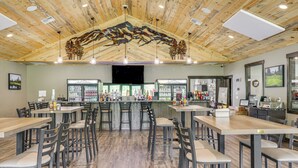 A restaurant with wooden ceiling, bar area, and multiple seating arrangements. - Deck & Mtn Views: Libby Home on Golf Course! (Libby)