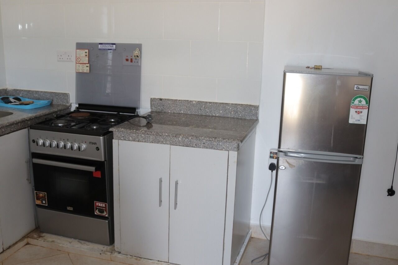 A kitchen with a stove, oven, and refrigerator.