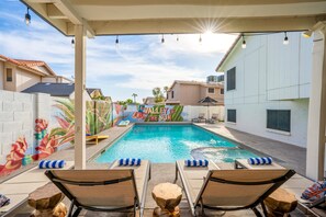 A swimming pool with lounge chairs and a mural titled "Valley of the Sun" in the background.