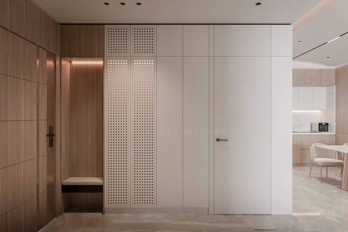 A modern interior with a wooden panel wall, a white door with a perforated panel, and a seating area with a bench.
