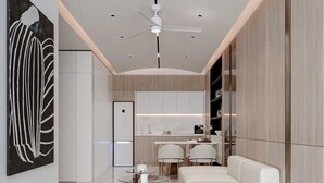 A modern interior with a sofa, a dining area, and a kitchen. -  Oceanus Vien Trieu Nha Trang Apartment - Thai Ha (Bac Nha Trang)