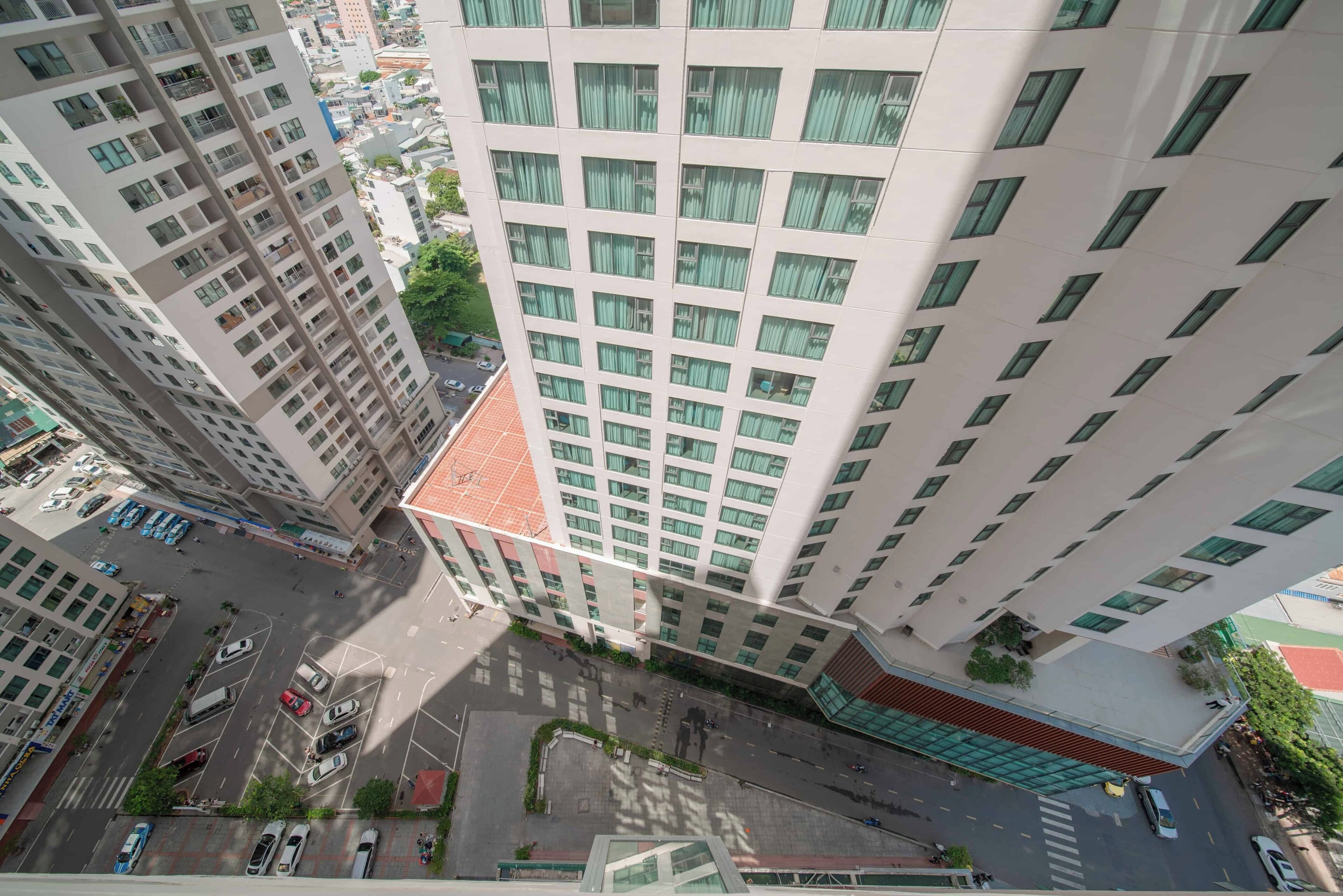 A high-rise building with multiple floors, large windows, and a central courtyard.
