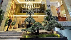 The exterior of 22Land Hotel Saigon with a modern facade, large glass windows, and a well-lit entrance. - 22Land Hotel Saigon (Ho Chi Minh City)
