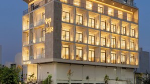 A multi-story hotel with a modern design, featuring balconies and large windows. - 7 Rays Hotel (Udaipur)