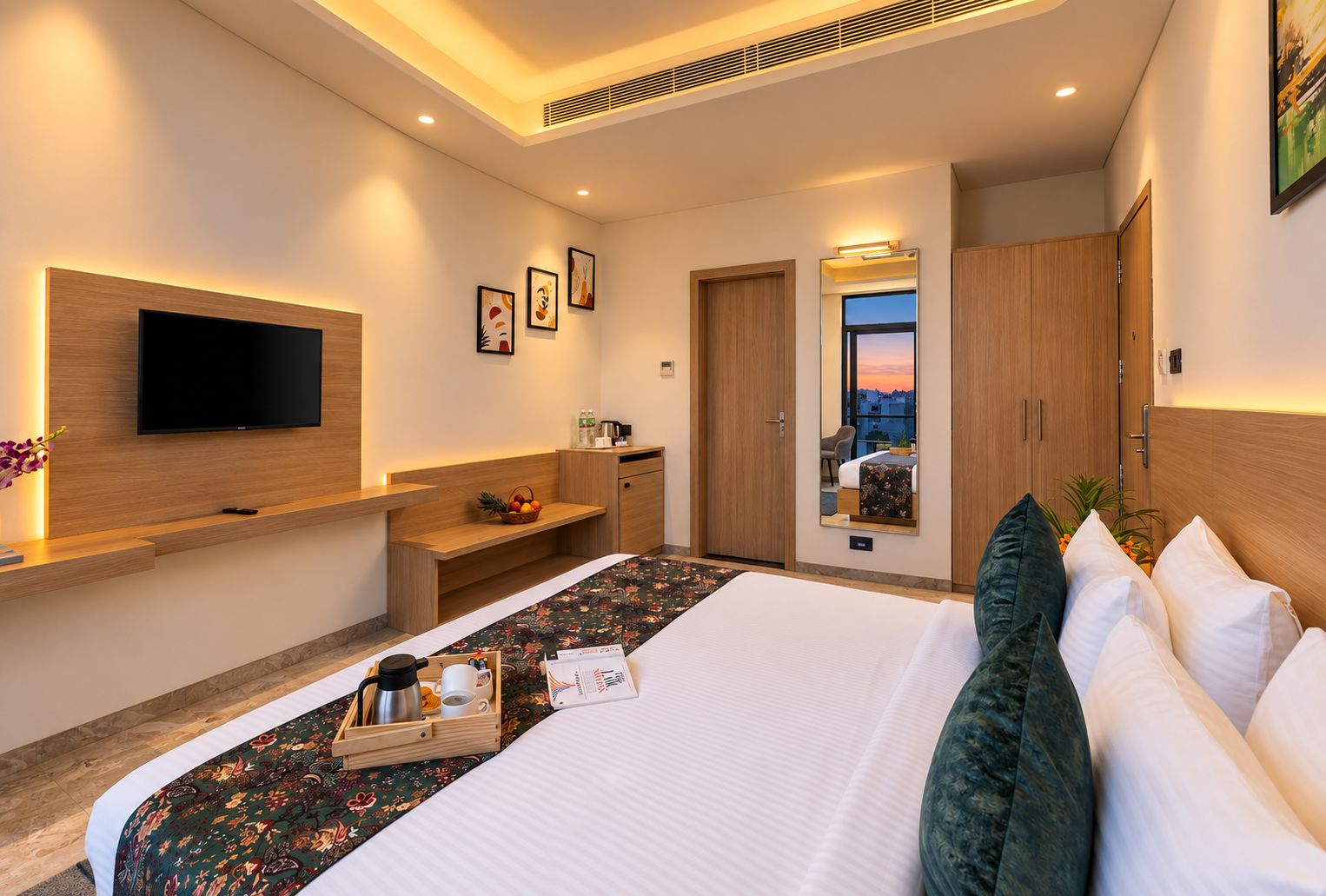 A hotel room with a bed, a TV, a desk, and a mirror.