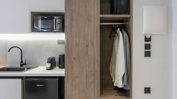 A modern kitchen with a built-in microwave, a coffee machine, and a dishwasher.