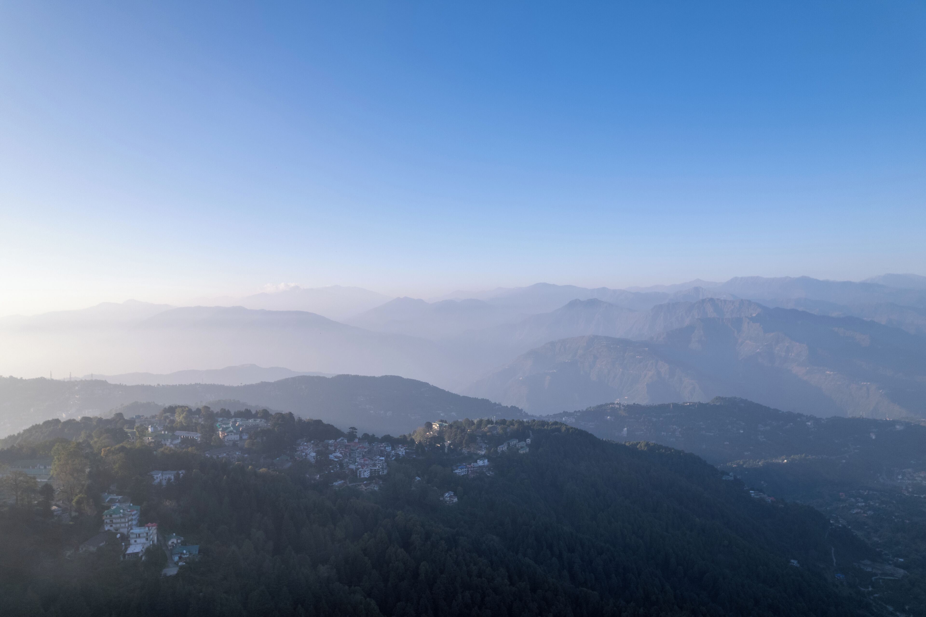 A mountainous landscape with a village nestled in the valley.