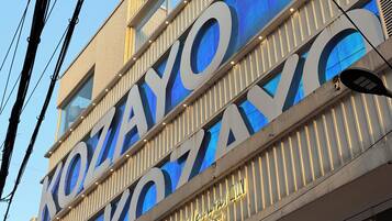 A building with large illuminated signage for 'Kozayo Coffee & Beer'.