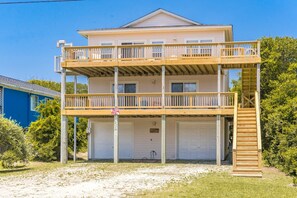 A two-story house with a balcony and a garage. - Almost Beachfront - Cozy 2nd Row Home with 4 Bedrooms (Surf City)