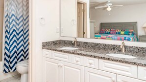 A bathroom with two sinks, a mirror, and a shower curtain. - Almost Beachfront - Cozy 2nd Row Home with 4 Bedrooms (Surf City)
