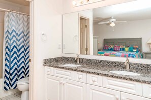 A bathroom with two sinks, a mirror, and a shower curtain. - Almost Beachfront - Cozy 2nd Row Home with 4 Bedrooms (Surf City)