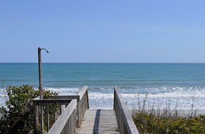 A wooden boardwalk leading to the ocean with a metal lamp post on the left. - Oceanic: Spacious 6BR oceanfront home (Surf City)