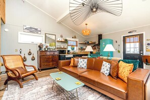 A cozy living room with a sofa, armchair, and a coffee table.