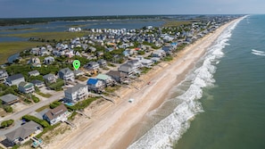 An aerial view of a coastal residential area with houses, a beach, and a body of water. - Sea View - 3 bedroom, 2 bath cottage in Surf City!  Dog Friendly! (Surf City)