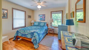 A bedroom with a bed, a ceiling fan, a desk, a chair, a lamp, and a window. - Sea View - 3 bedroom, 2 bath cottage in Surf City!  Dog Friendly! (Surf City)