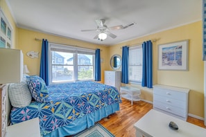 A bedroom with a bed, a desk, a dresser, a ceiling fan, and a window with curtains. - Sea View - 3 bedroom, 2 bath cottage in Surf City!  Dog Friendly! (Surf City)