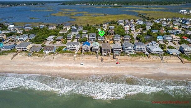 An aerial view of a coastal residential area with houses, a beach, and a body of water. - Sea View - 3 bedroom, 2 bath cottage in Surf City!  Dog Friendly! (Surf City)