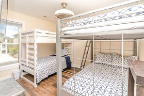 A bunk bed room with a window, a ladder, and a ceiling fan. - Surf Club - Oceanfront, 3 bedroom, gorgeous home in Surf City!  Dog Friendly! (Surf City)