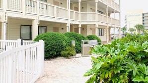 A multi-story hotel with balconies, a gated entrance, and a well-maintained garden area. - Ocean Dunes Villas #22, stay close to the ocean (Myrtle Beach)
