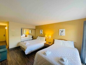 A hotel room with two beds, a desk, and a chair. - Ocean Dunes Villas #16, stay close to the beach (Myrtle Beach)