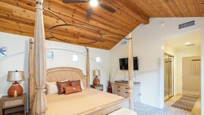 A four-poster bed with a wooden headboard, a ceiling fan, and a television on the wall. - Sedona RedRock Retreat | Hot Tub, Fire Pit & Views (Sedona)