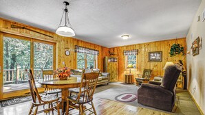 A wooden interior with a dining table, chairs, a sofa, and a recliner. - Peaceful Wautoma Retreat w/ Deck on 10 Acres! (Wautoma)