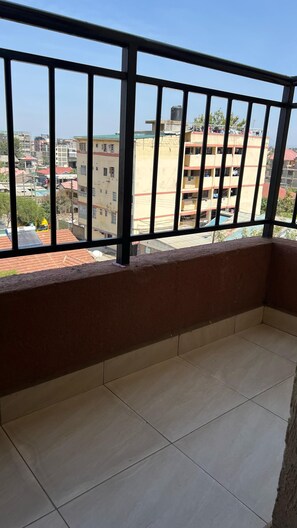 Enjoy a view of the surrounding residential area from this balcony.