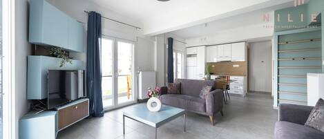 Family Apartment, Balcony, City View | Living area | Flat-screen TV