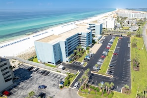 A hotel with a parking lot, a beach, and ocean views. - Islander Beach Resort 303 Condo by RedAwning (Fort Walton Beach)