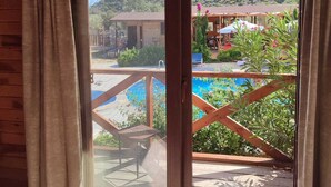 A wooden room with a sliding glass door leading to a pool area. - Habesa Bungalov & Apart (Kas)