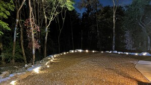 A gravel path with lights, surrounded by trees and rocks. - THE BIG HOUSE ~ With 620 sq ft EVENT SPACE ~ (view on YouTube "The Big House")
 (Nashville)