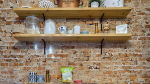 A rustic kitchen with wooden shelves, a bread bin, and two stools. - Cityside on North Prince, in Historic Downtown Lancaster (Lancaster)