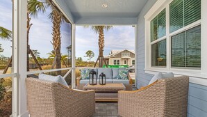 A covered outdoor seating area with wicker furniture and a view of a house in the background. - New 2 Bedroom + Den, 2 Bath Home w/2 Car Garage 10 Min from Downtown Naples (Naples)