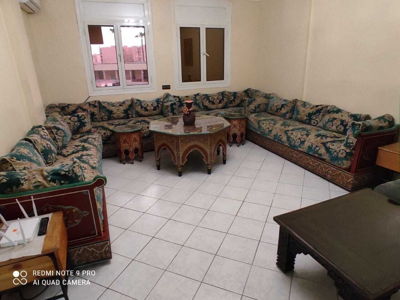 A living room with a sofa set, a coffee table, and a TV stand.