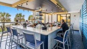 An outdoor bar area with a counter and seating. - Oceans Crest! Oceanfront View Pools Putt Putt Spa (Myrtle Beach)