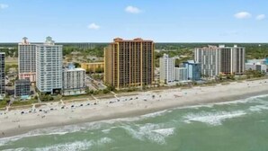 A coastal cityscape with high-rise buildings, a beach, and the ocean. - Oceans Crest! Oceanfront View Pools Putt Putt Spa (Myrtle Beach)