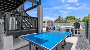 Enjoy a game of ping pong in a well-maintained outdoor area with a clear playing space.