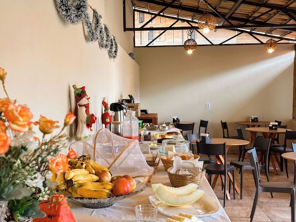 A dining area with tables, chairs, and a variety of food items on display.